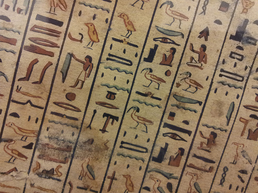 The hieroglyphs are in vertical columns and quite brightly coloured. They sit slightly on a slant; not perfectly vertical