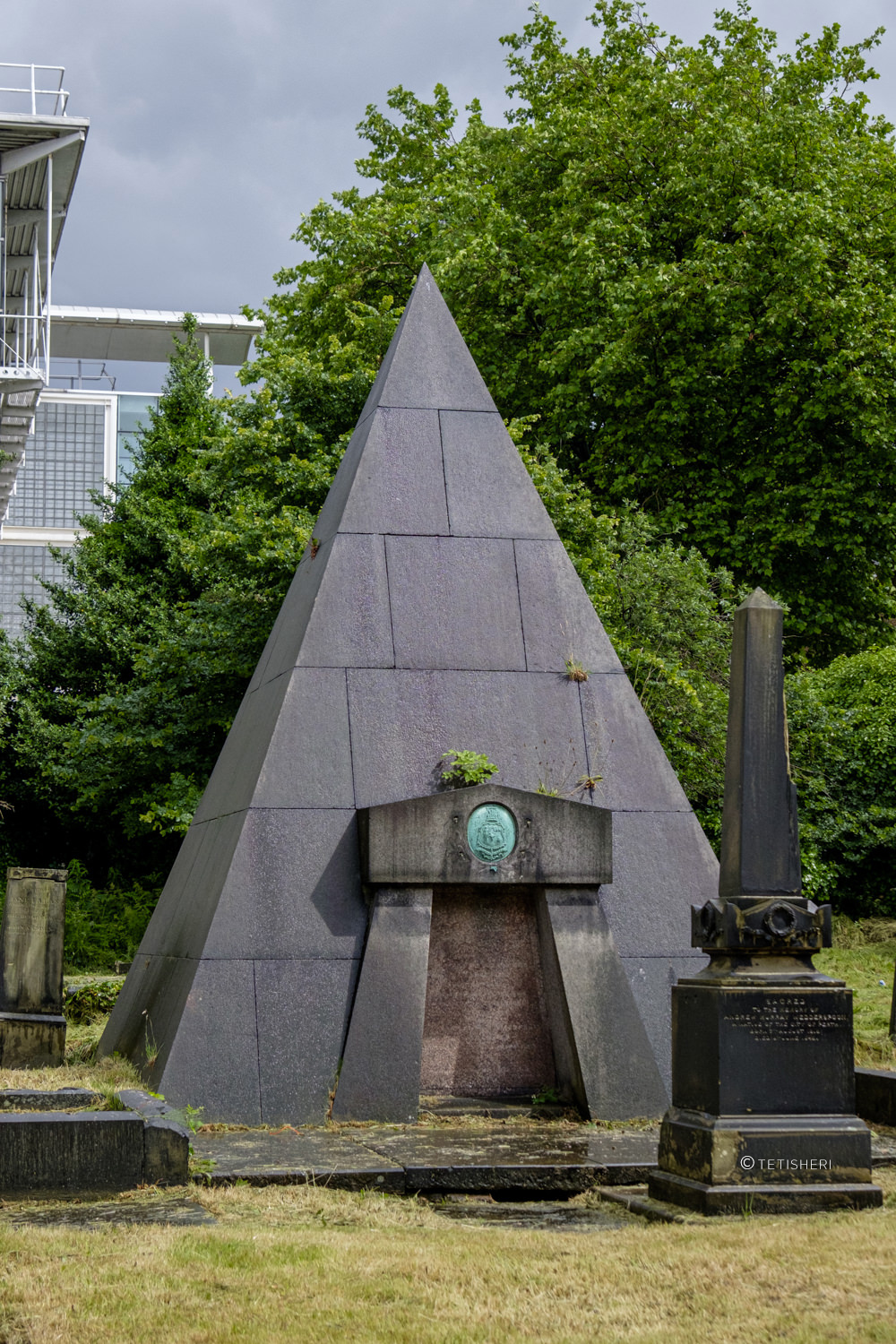 a pyramid-shaped tomb in a graveyard