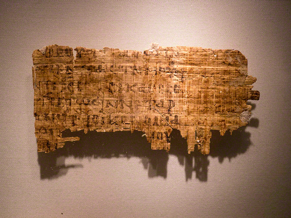 A small rectangular fragment, the writing is badly faded and quite difficult to see in places. The writing is in black ink, in large, bold letters