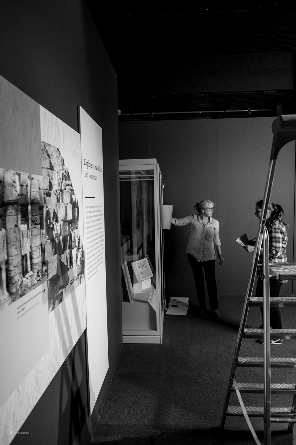 conservators putting artefacts into a museum case