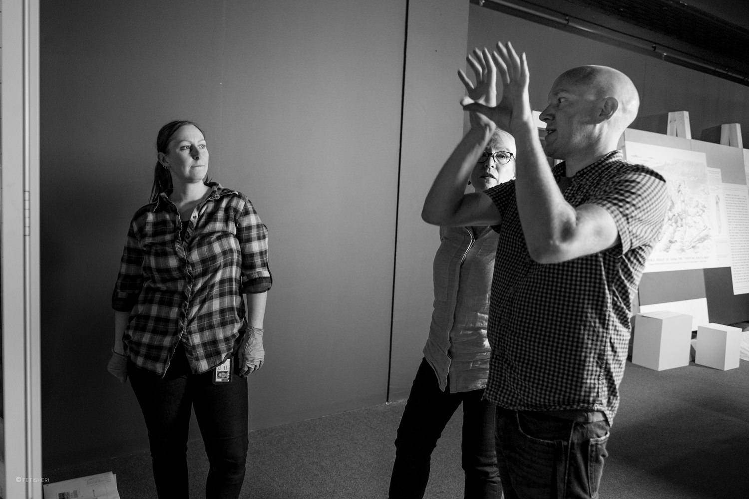 a museum curator and museum conservators in a gallery