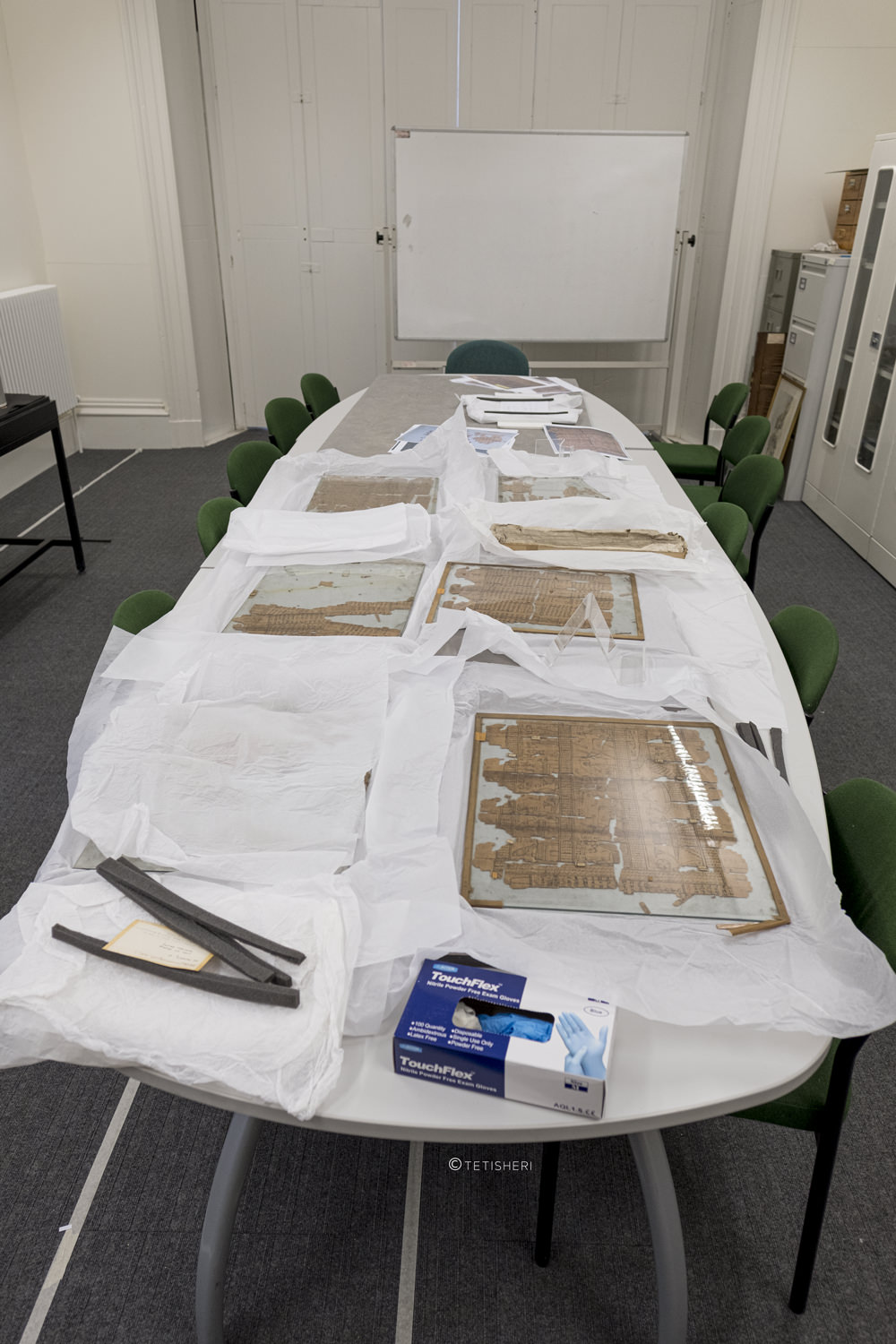 a table with sheets of egyptian papyrus