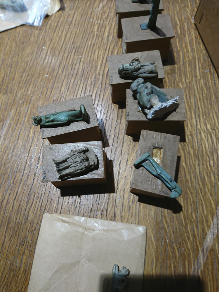 Several ancient Egyptian amulets on a table