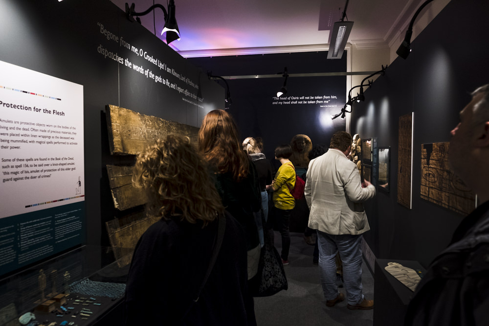 People in a museum gallery looking at artefacts