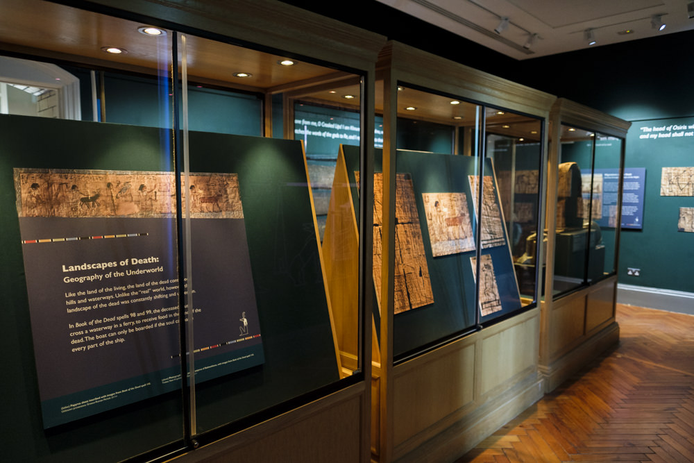 A museum gallery with images and artefacts from ancient Egypt