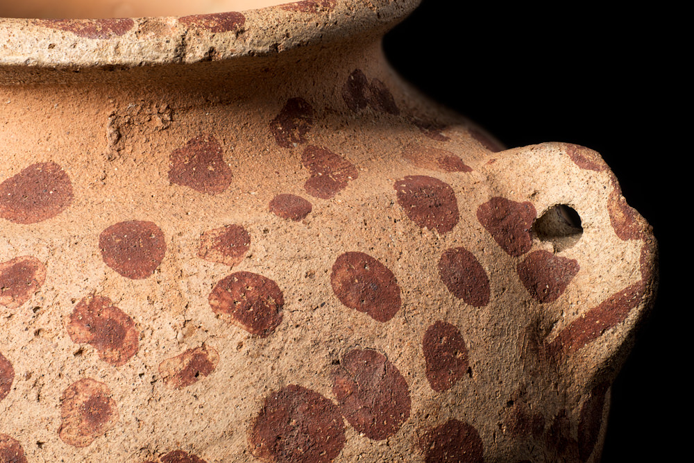 The side of a small, round pot with a lug-shaped handle from Predynastic Egypt