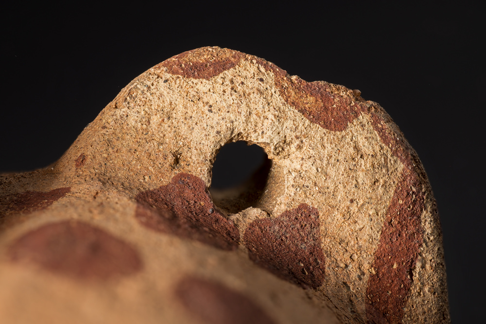 A photo of the lug-handle of an ancient Predynastic pot using selective focus