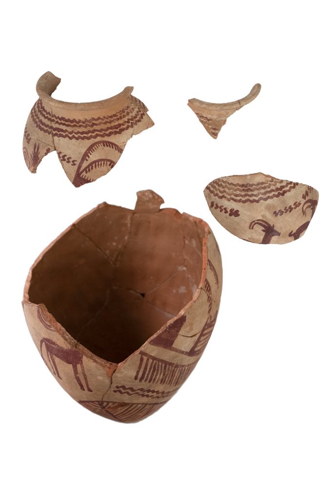 A large ancient Egyptian Predynastic pot with painted decoration, in pieces before conservation