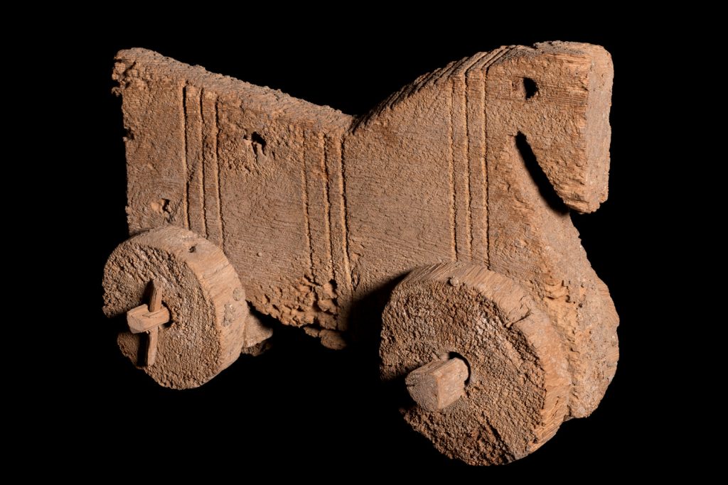 An ancient Egyptian wooden toy horse with wheels