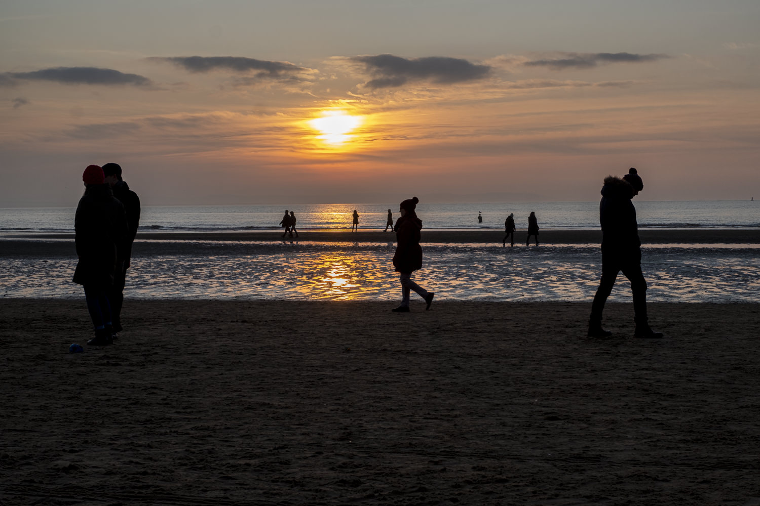 people walking on a beach