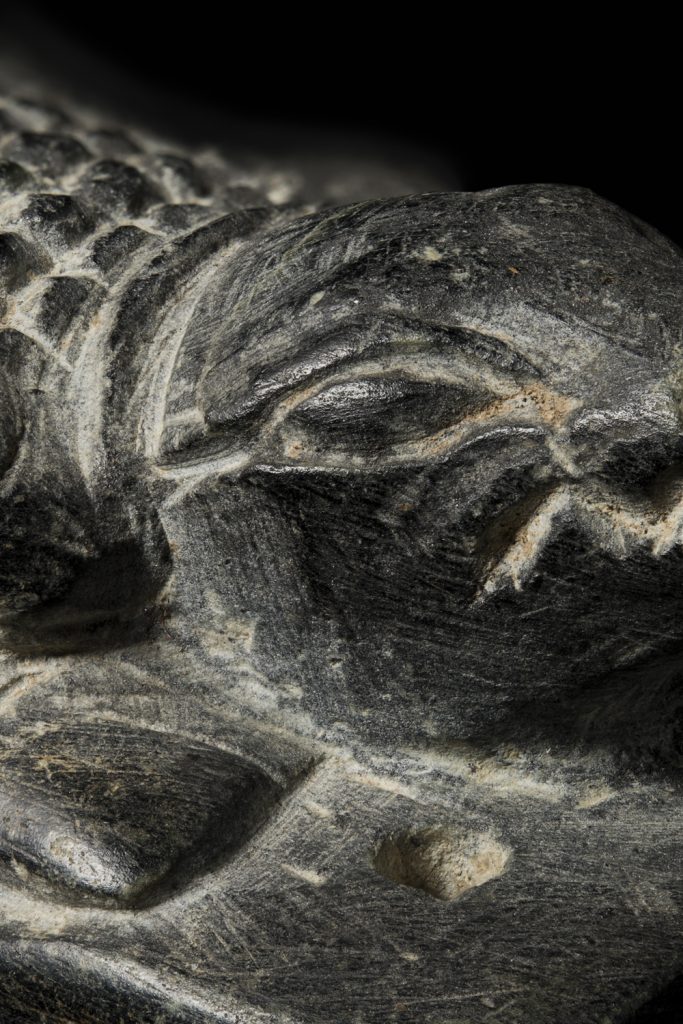 detail of a small stone carved ancient egyptian crocodile