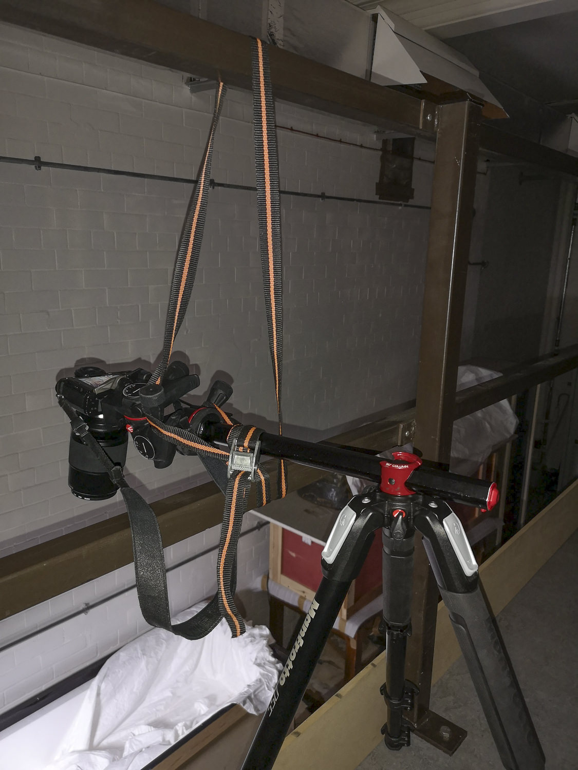 a camera on a tripod tied to some railings