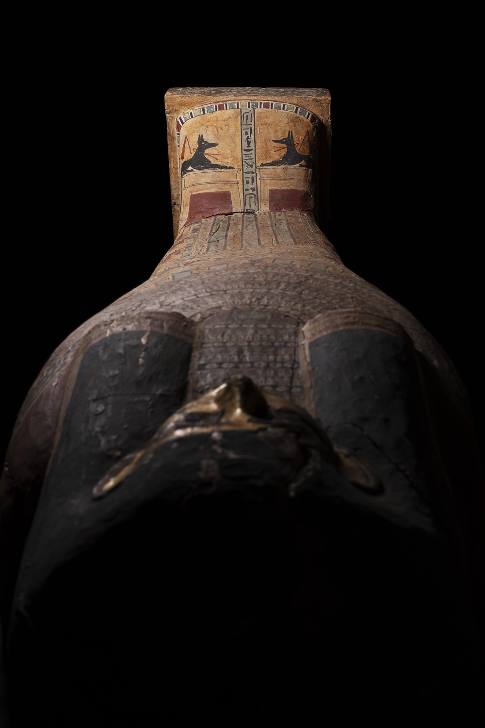 an ancient egyptian coffin with anubis on the feet