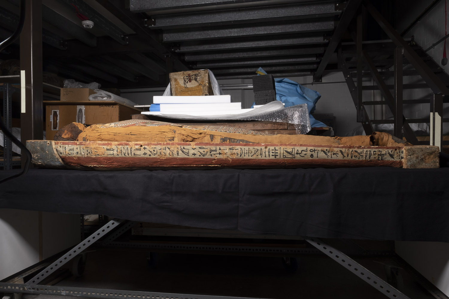 an egyptian coffin in a museum storeroom