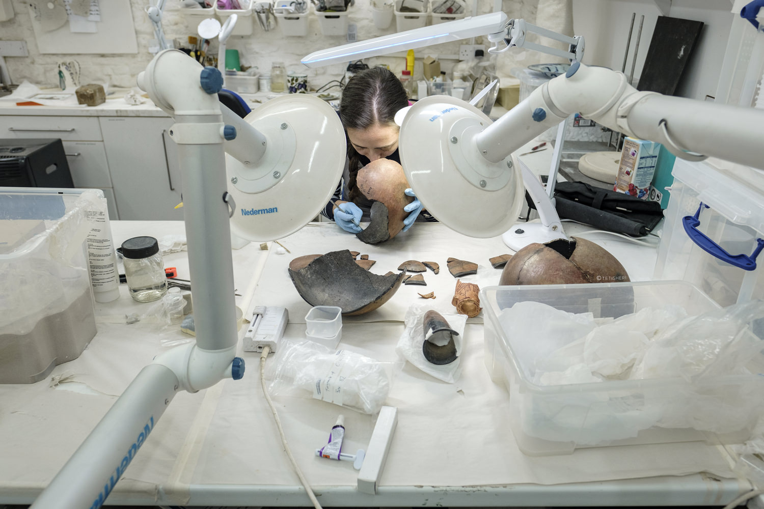 A conservator repairing an ancient Egyptian pot