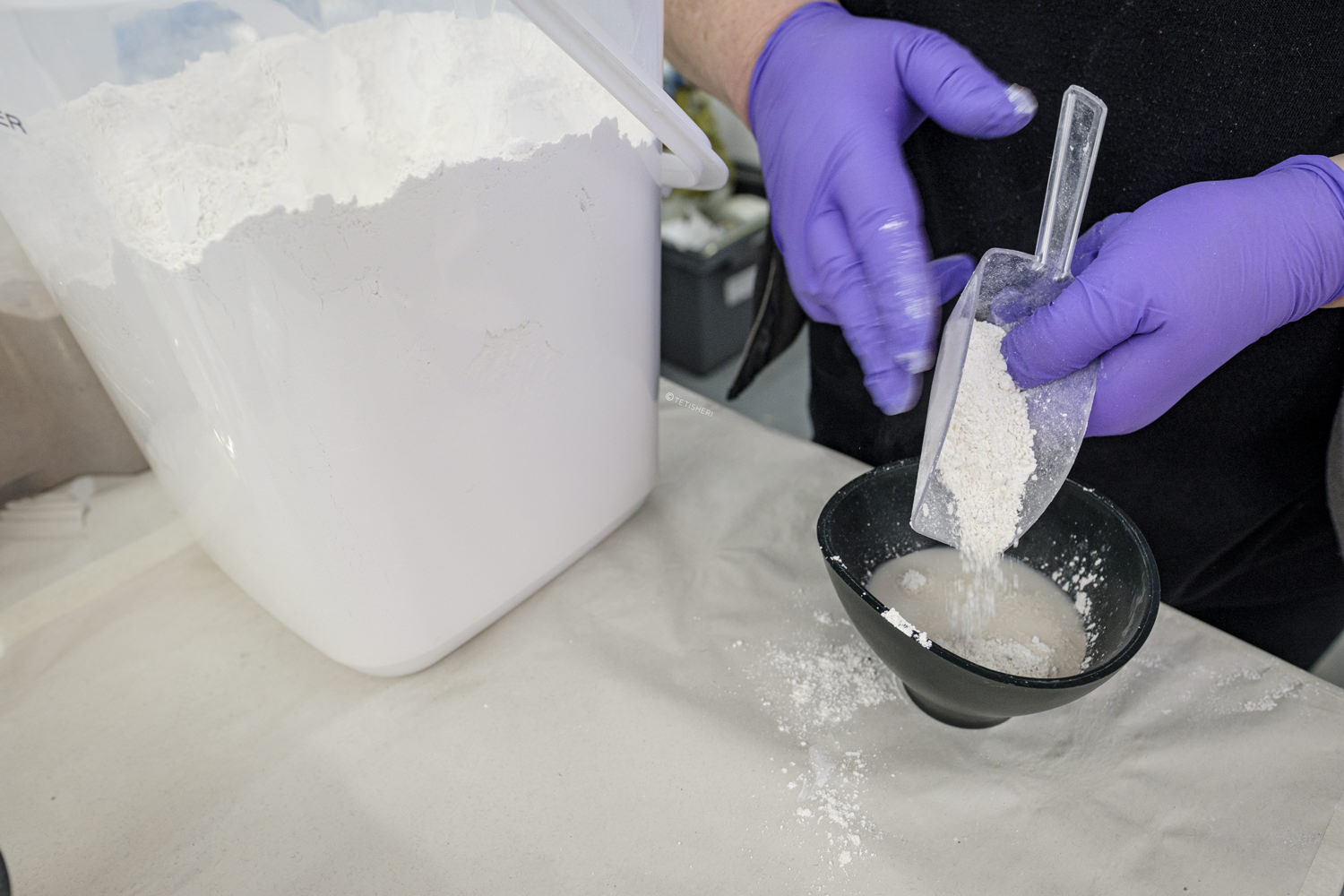 Closeup of a pair of hands preparing plaster of Paris