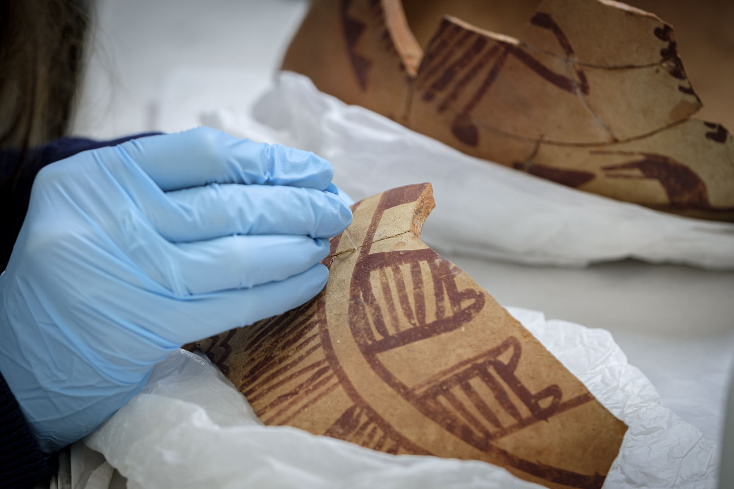 A conservator repairing an ancient Egyptian pot