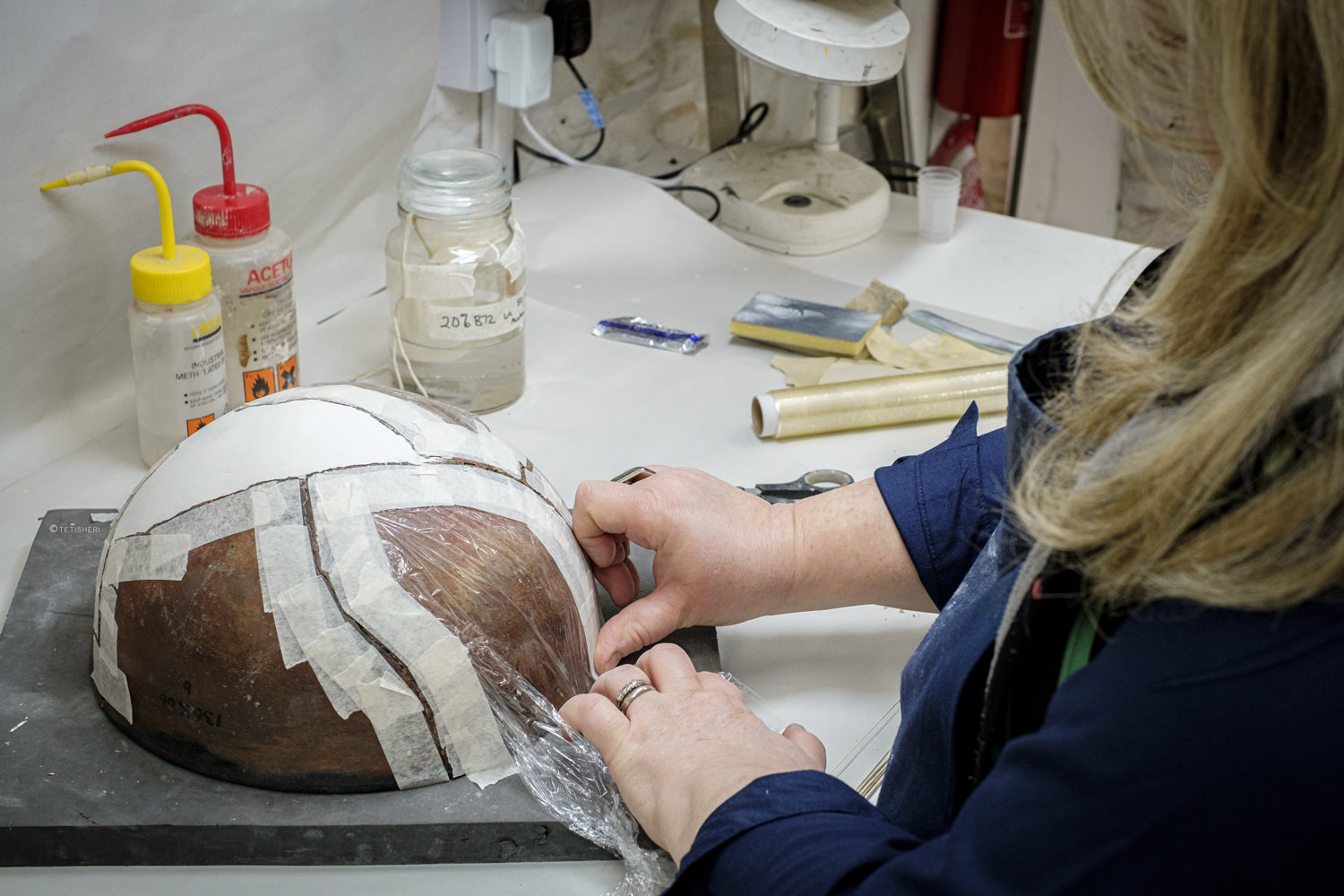 a conservator repairing an ancient egyptian bowl