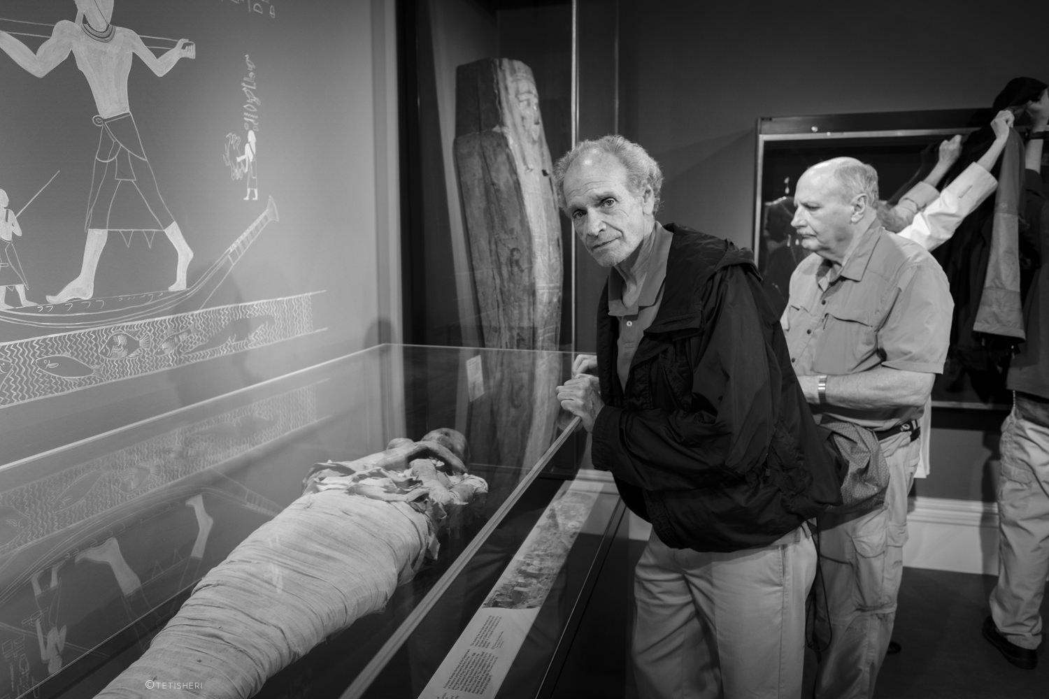 a man standing in front of an ancient egyptian mummy