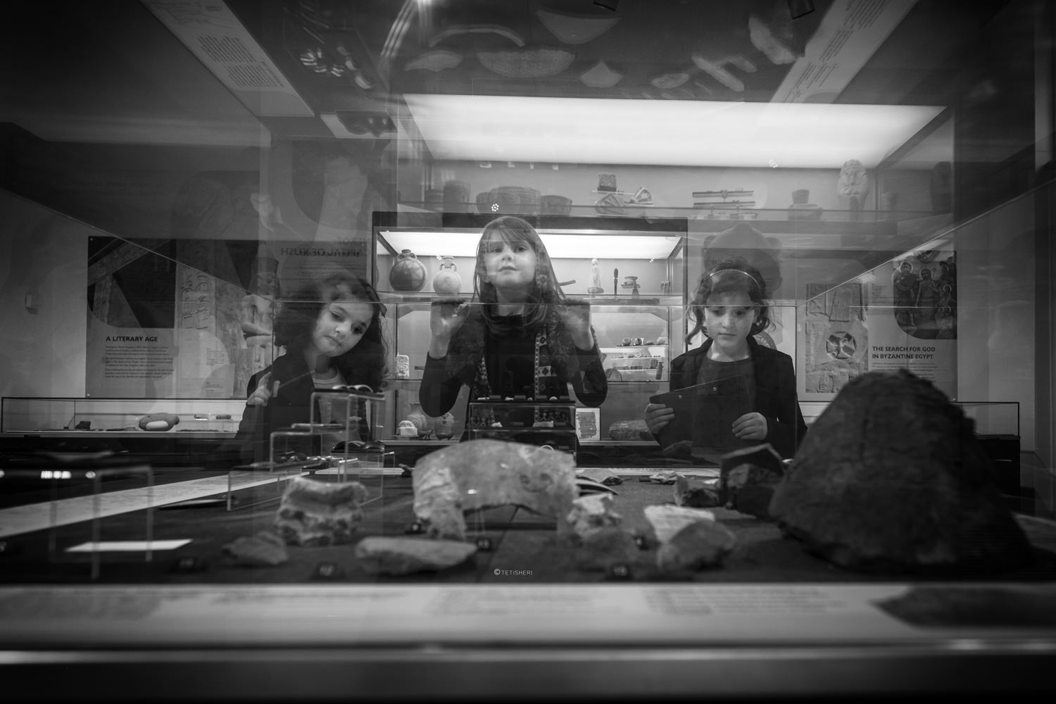 three girls looking at egyptian artefacts in a museum