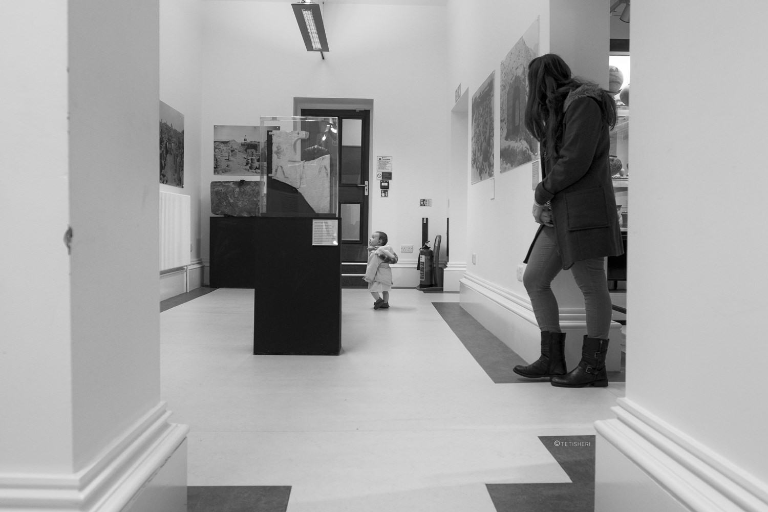 a woman and toddler in a museum gallery