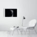 product image of the 51 by 71 cm re and mehen photo print on a wall next to a chair and foot rest