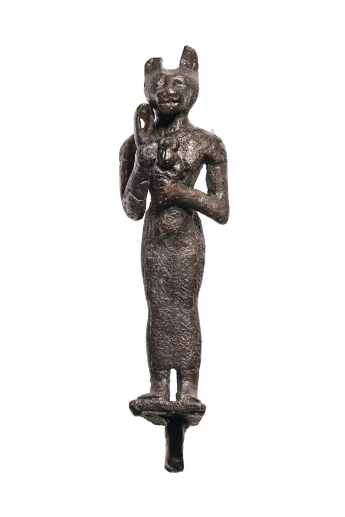 A bronze statuette of Bast as a woman with a cat's head. She's holding a sistrum and a scarab beetle.