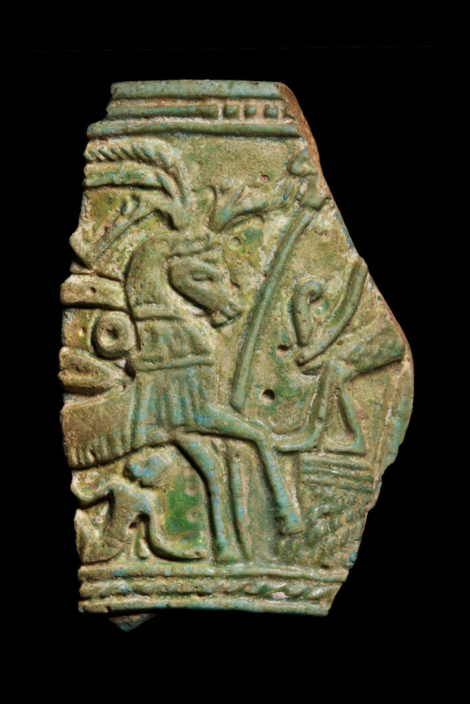 A fragment of green faience decorared with a horse.