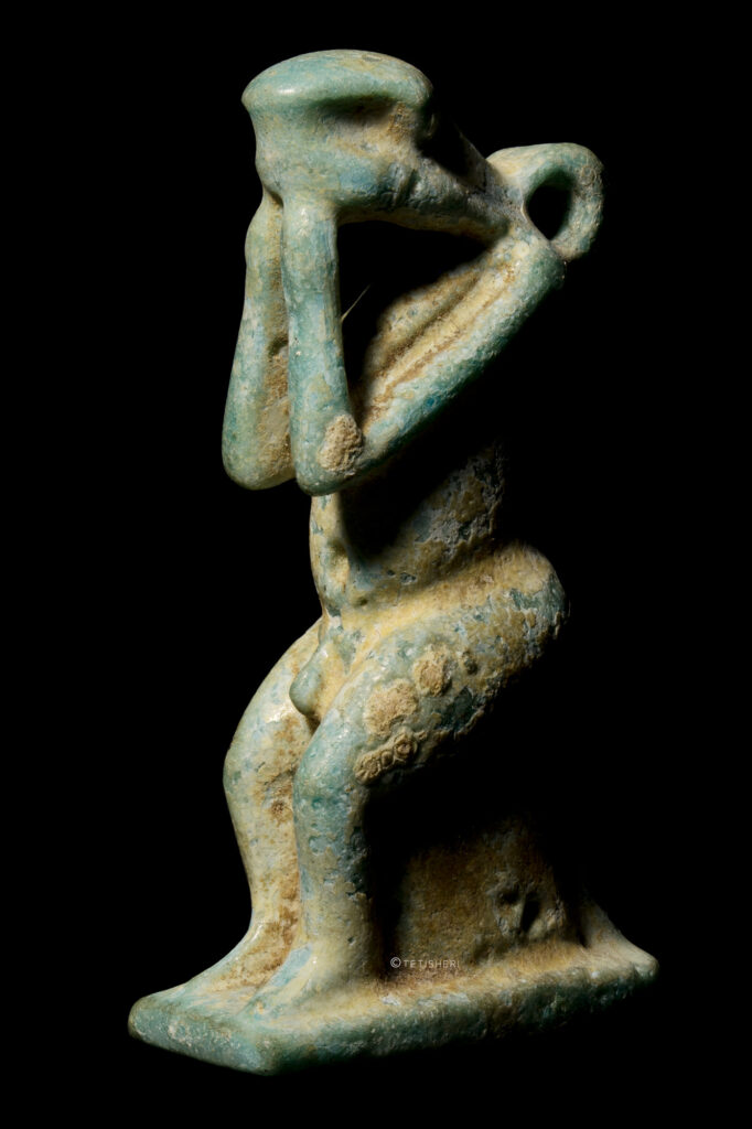 A blue faience Egyptian amulet of Neheb-kau - a human with a snake head.